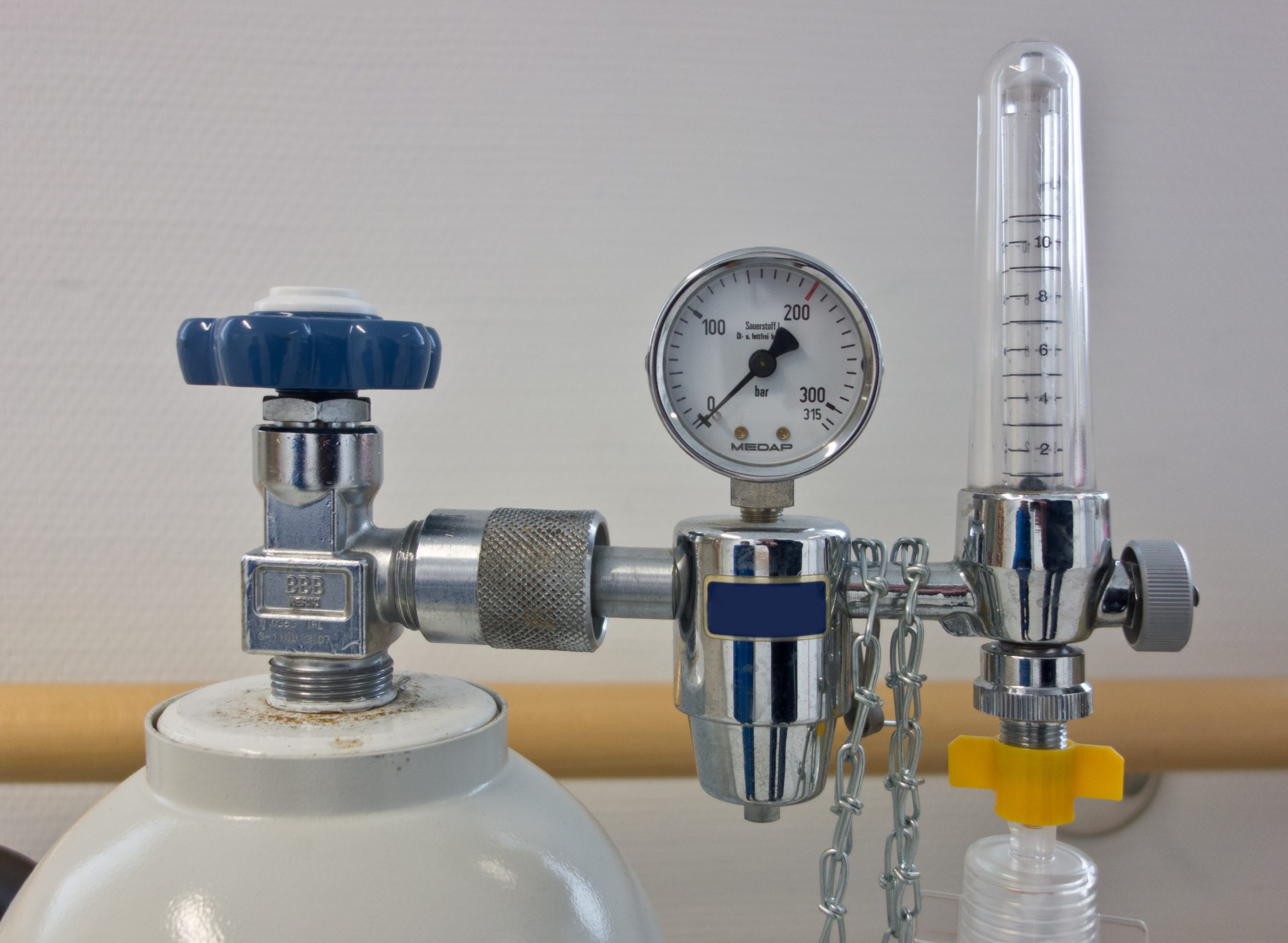 The top of an oxygen tank, showing the pressure gauge and valve.
