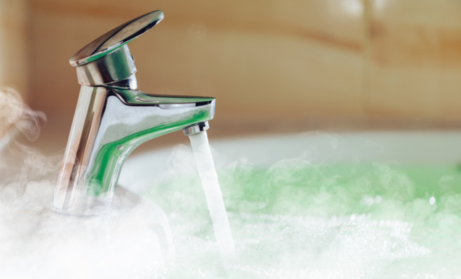 A running tap with steamy hot water beneath.