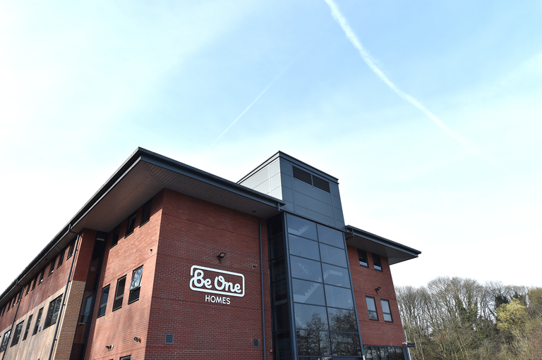 The side of our main Valley House office building. The sky is blue and the Be One Homes logo is visible on the close side of the building.