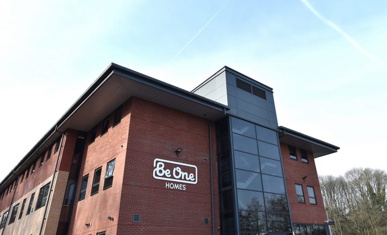 The side of our main Valley House office building. The sky is blue and the Be One Homes logo is visible on the close side of the building.