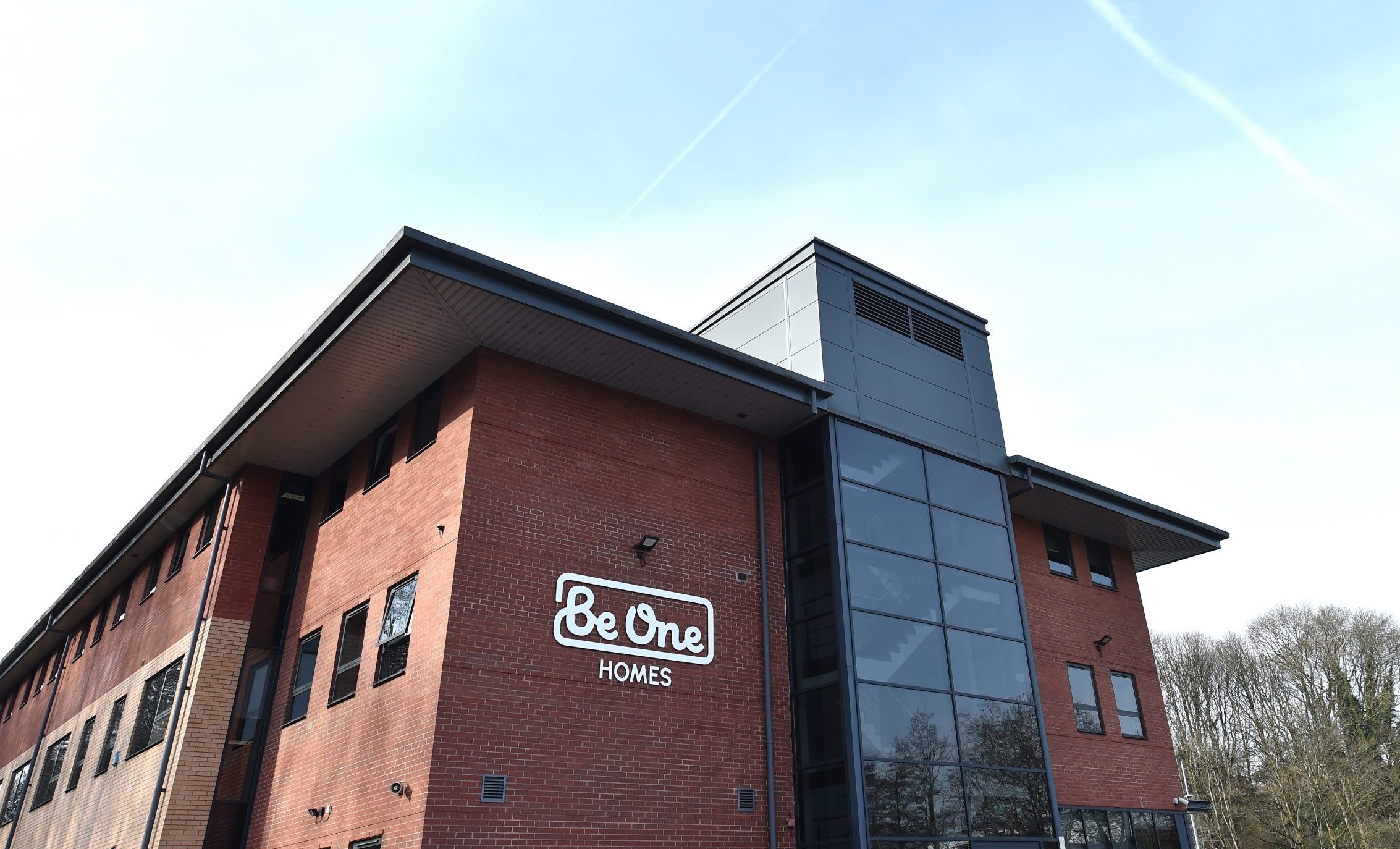 The side of our main Valley House office building. The sky is blue and the Be One Homes logo is visible on the close side of the building.