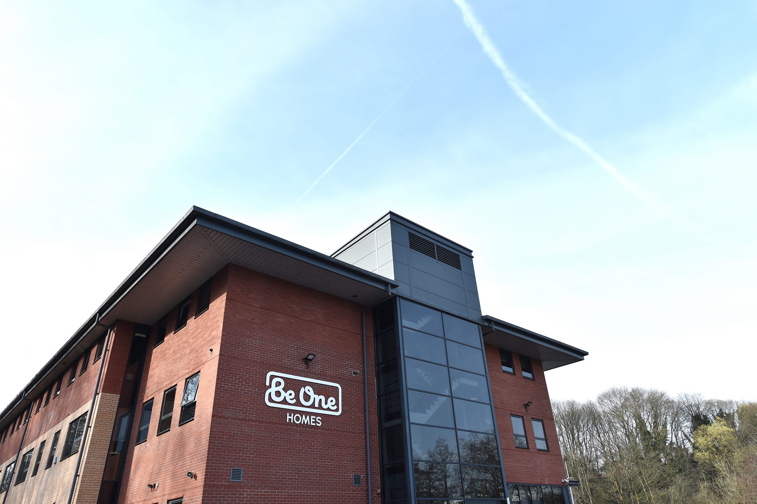 The side of our main Valley House office building. The sky is blue and the Be One Homes logo is visible on the close side of the building.