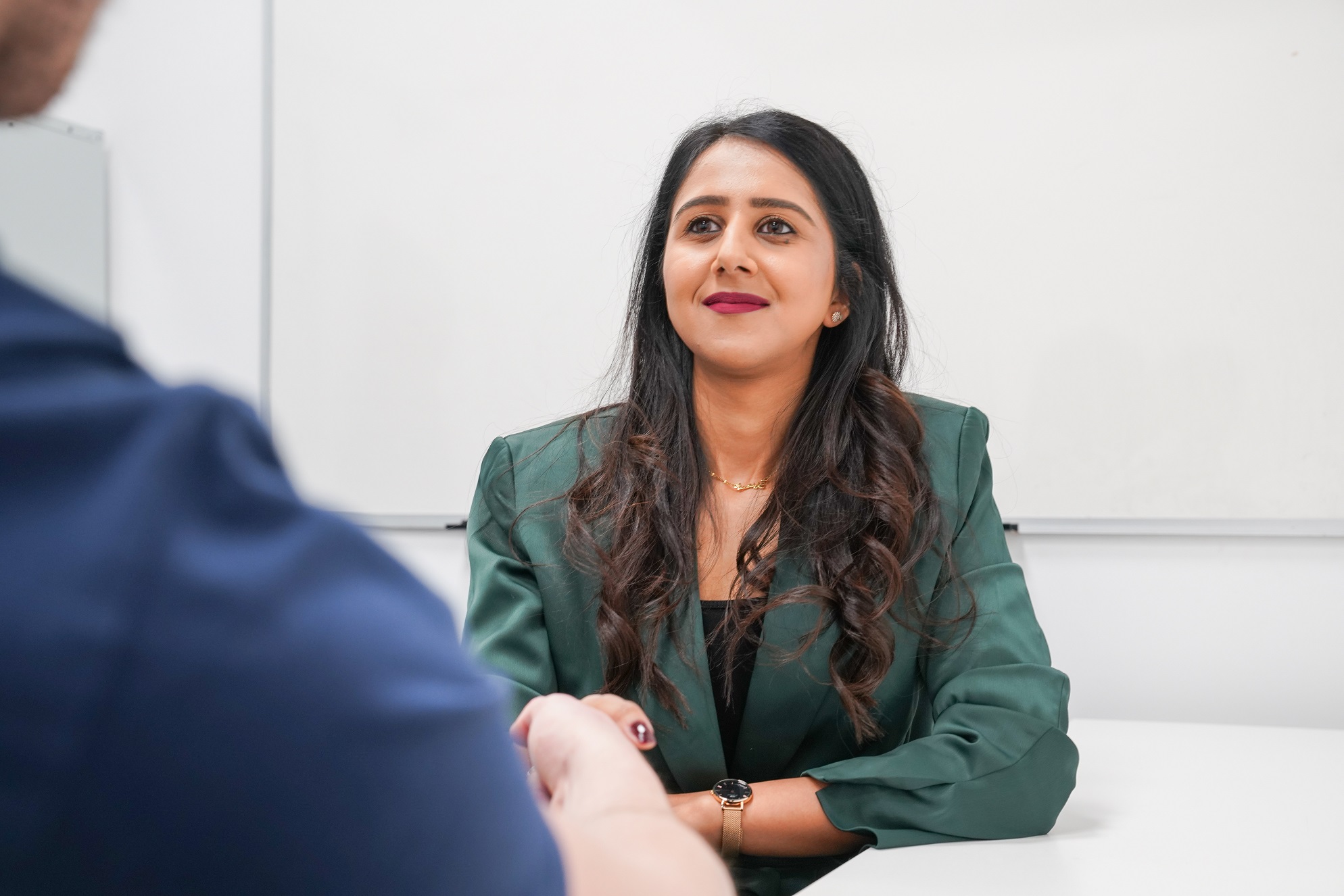 Shaira, the lead for our Working Wardrobe interview clothing and preparation scheme, shakes hands with a client.