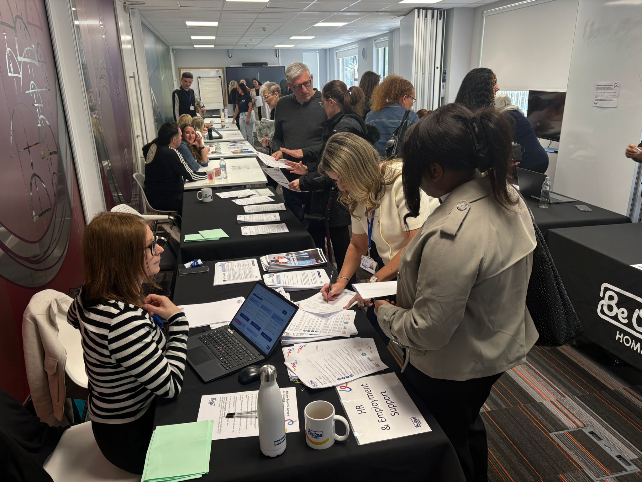 Colleagues and customers at our 20% Careers in Housing event on Wednesday 29 April. There are stalls where colleagues share details on different career paths within Be One Homes.