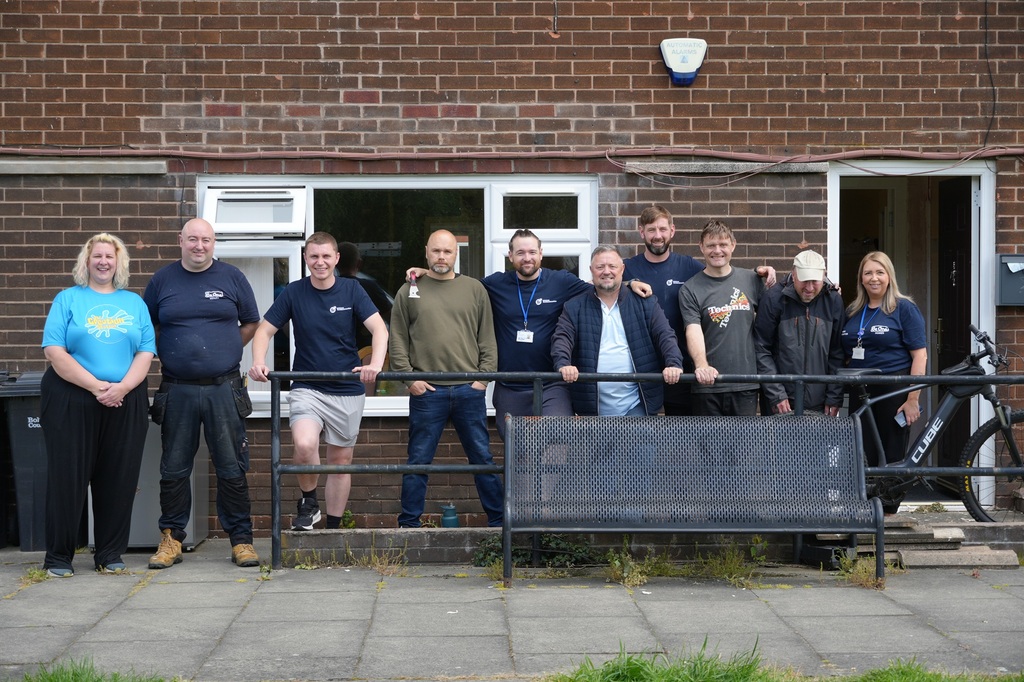 Image of a group of Be One Homes colleagues and local volunteers who helped decorate the Manbassadors 'Living Room' space in Little Lever, Bolton.