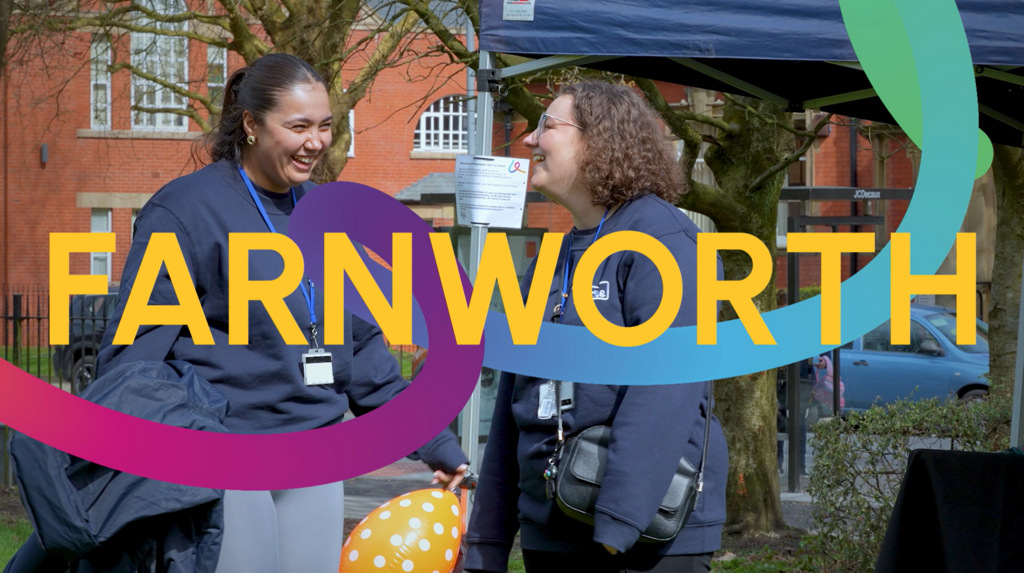 A thumbnail image from our short film on the Farnworth Focus project. It shows two female Be One Homes colleagues laughing and smiling together at an outdoor community event.