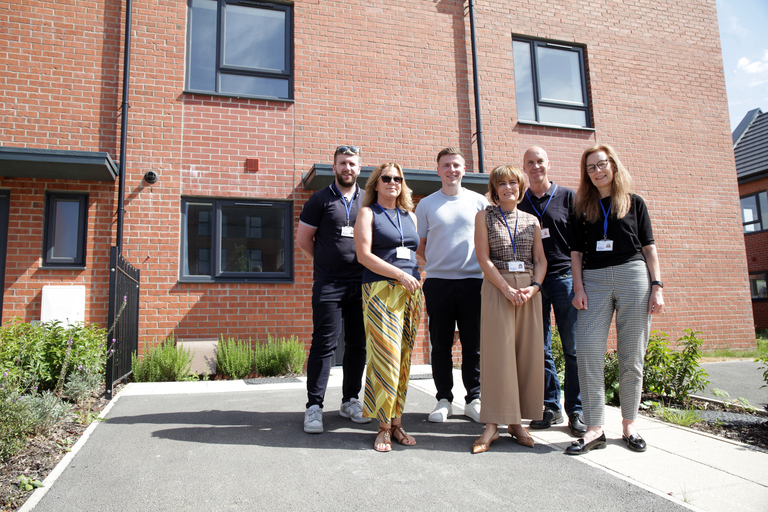 Colleagues from Be One Homes stand outside a newly completed shared ownership home at Rivington Chase.